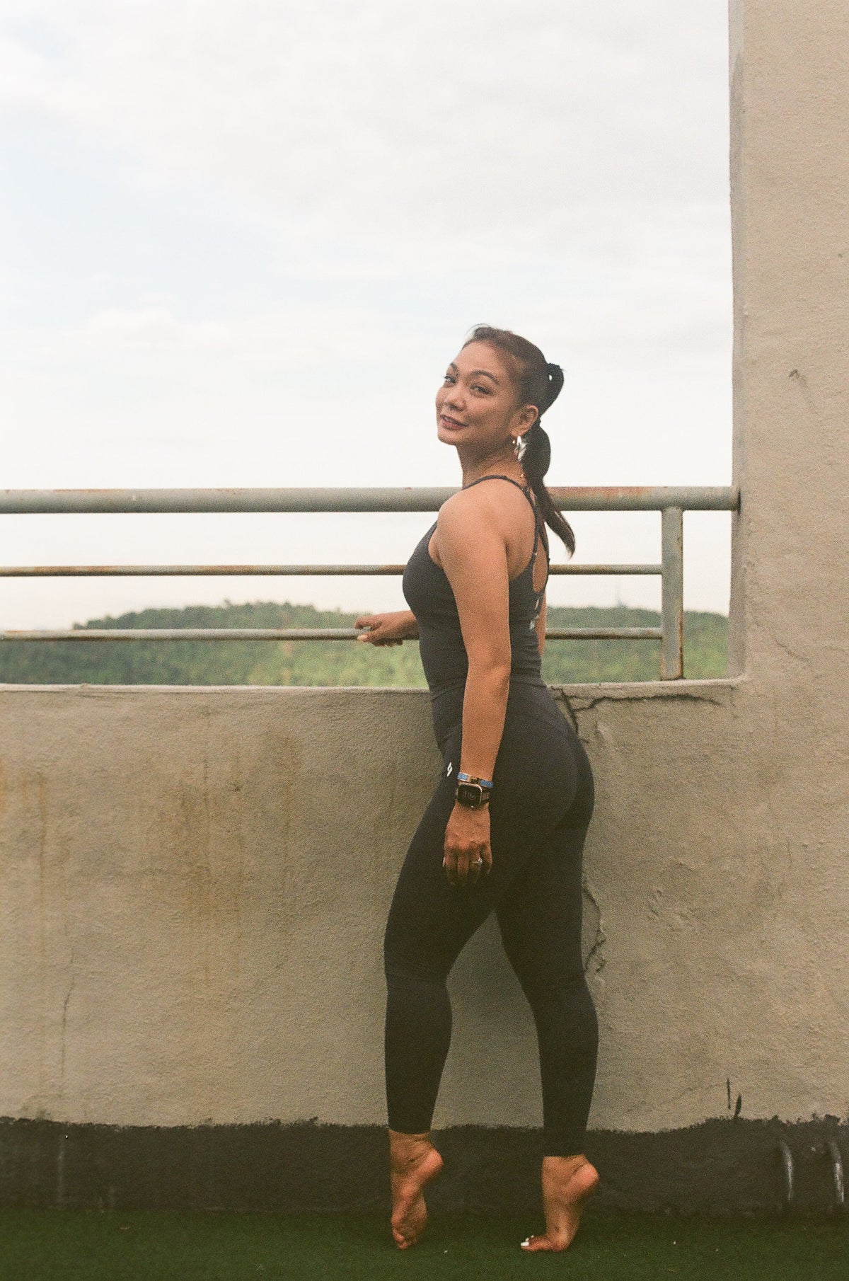 EQL x RAH contoured high-waisted leggings in Blue Grey, full length on a rooftop